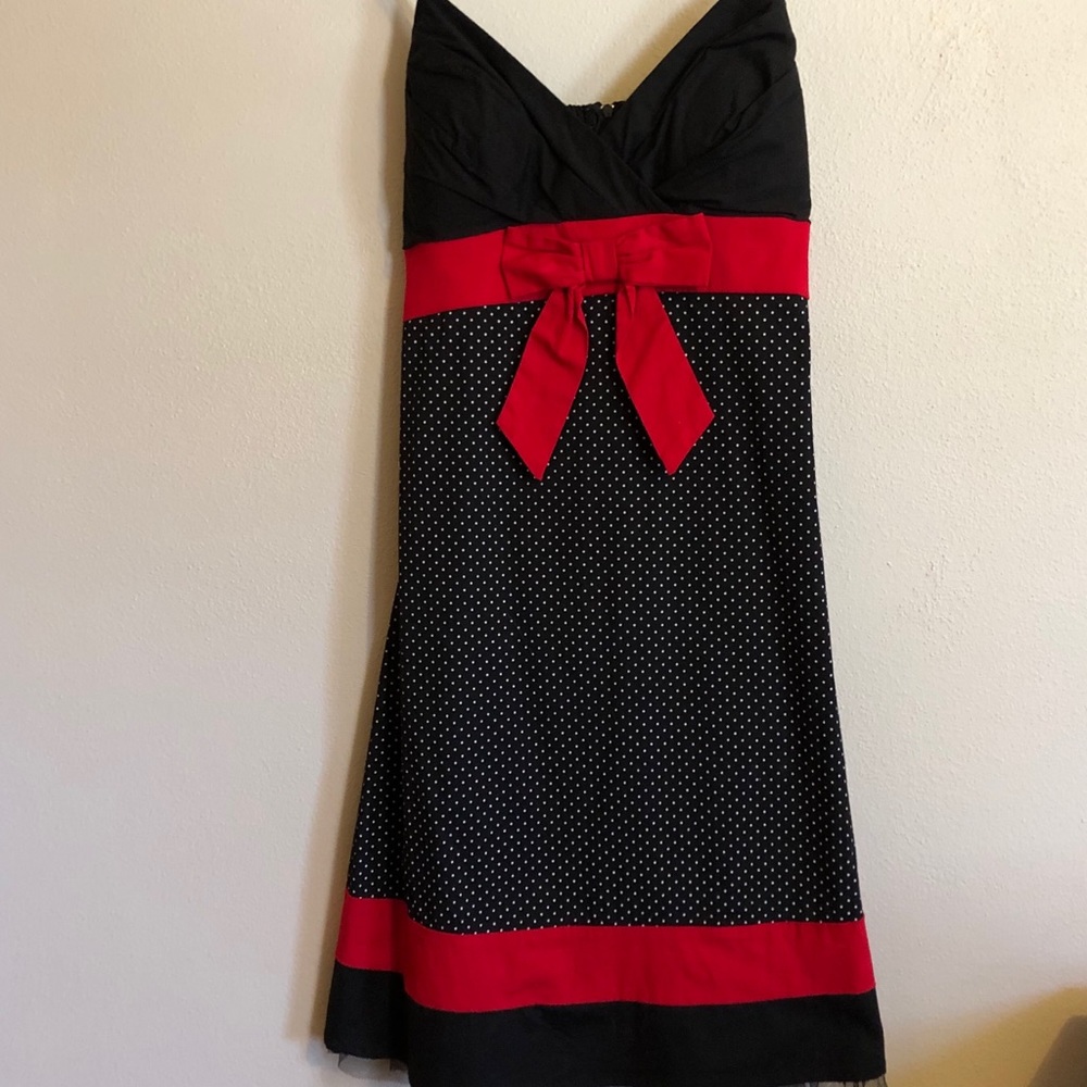Black dress with white polka dots and red accents